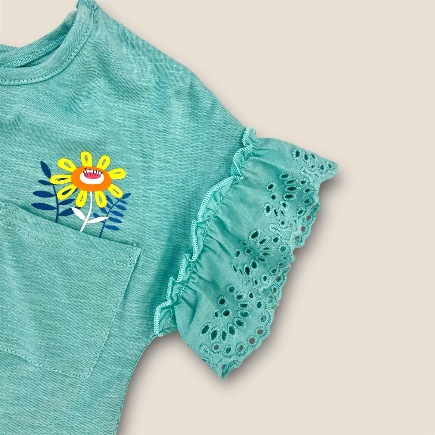 Vestido turquesa con flores y volantes.
