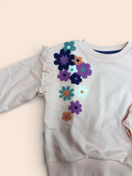 Sudadera rosa con flores bordadas y volante en manga