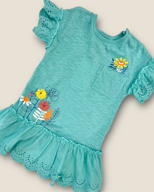 Vestido turquesa con flores y volantes.