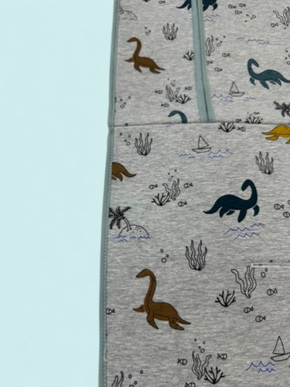 Colchoneta universal gris con dinosaurios marinos y vivos azulados Peques del Valle