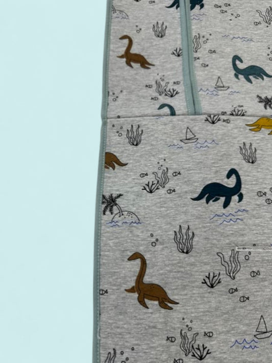 Colchoneta universal gris con dinosaurios marinos y vivos azulados Peques del Valle