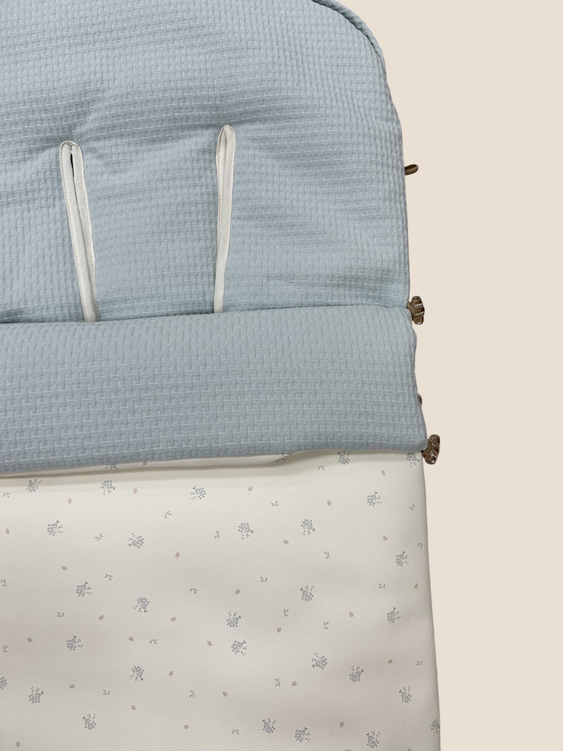 Saco para silla de paseo azul bebé con estampado floral y base blanca UZTURRE