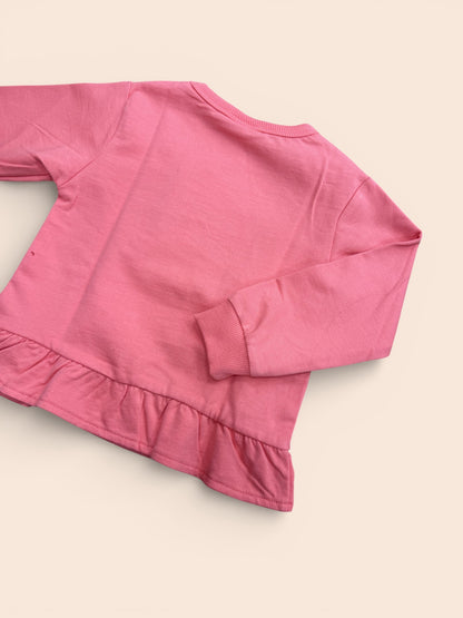Sudadera  rosa con formas geométricas y volante