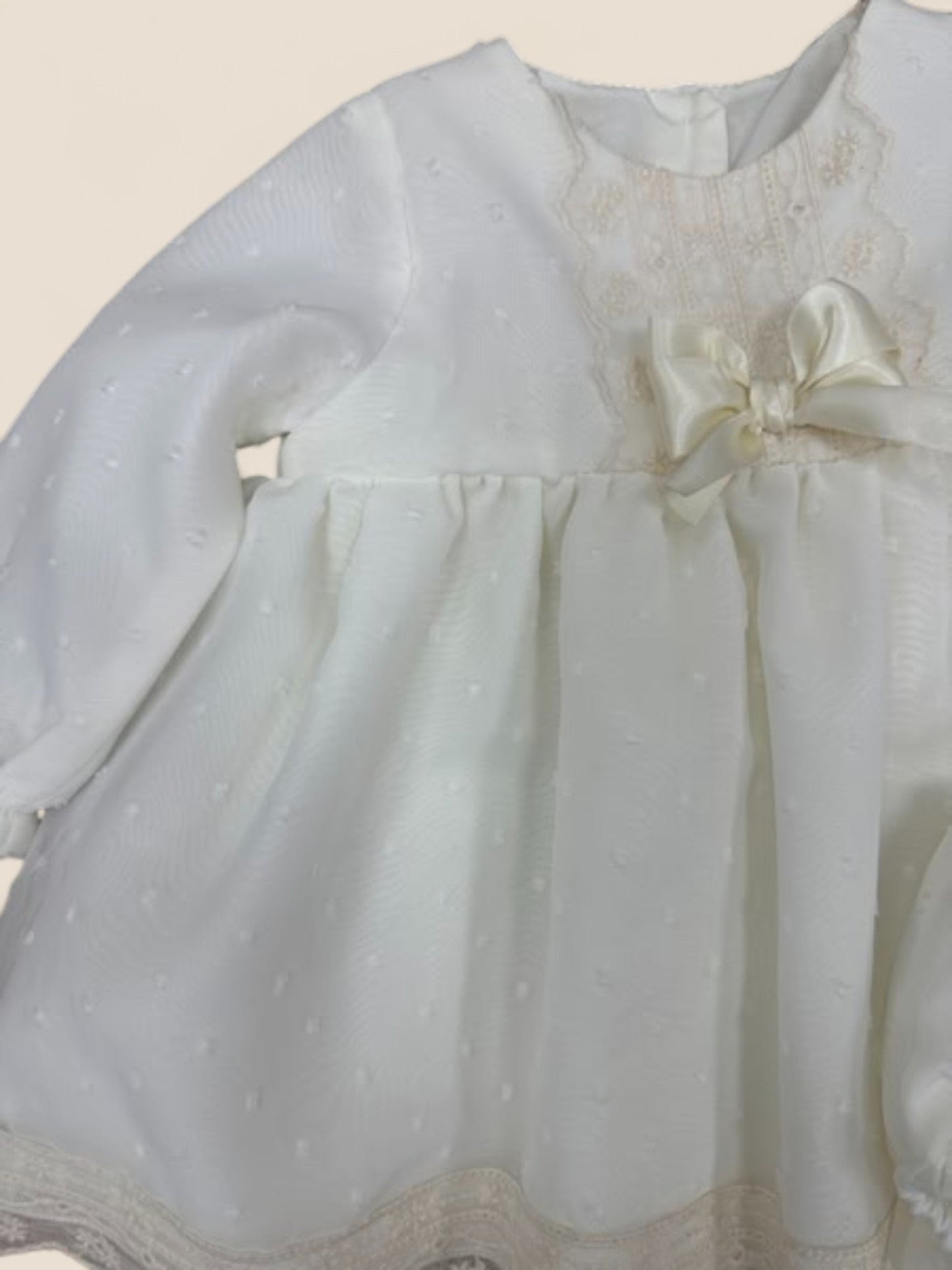 Vestido bebé en plumeti blanco con puntilla y lazo marfil Eva Martinez